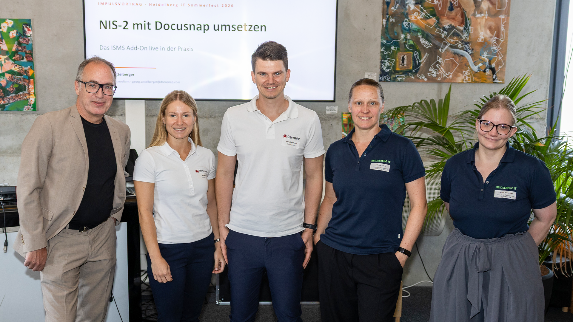 Docusnap consultants Georg Sattelberger and Barbara Ull with representatives from Docusnap partners Heidelberg iT Management and Medialine Group in front of the "NIS-2 mit Docusnap umsetzen" presentation at their joint summer fest 2026.